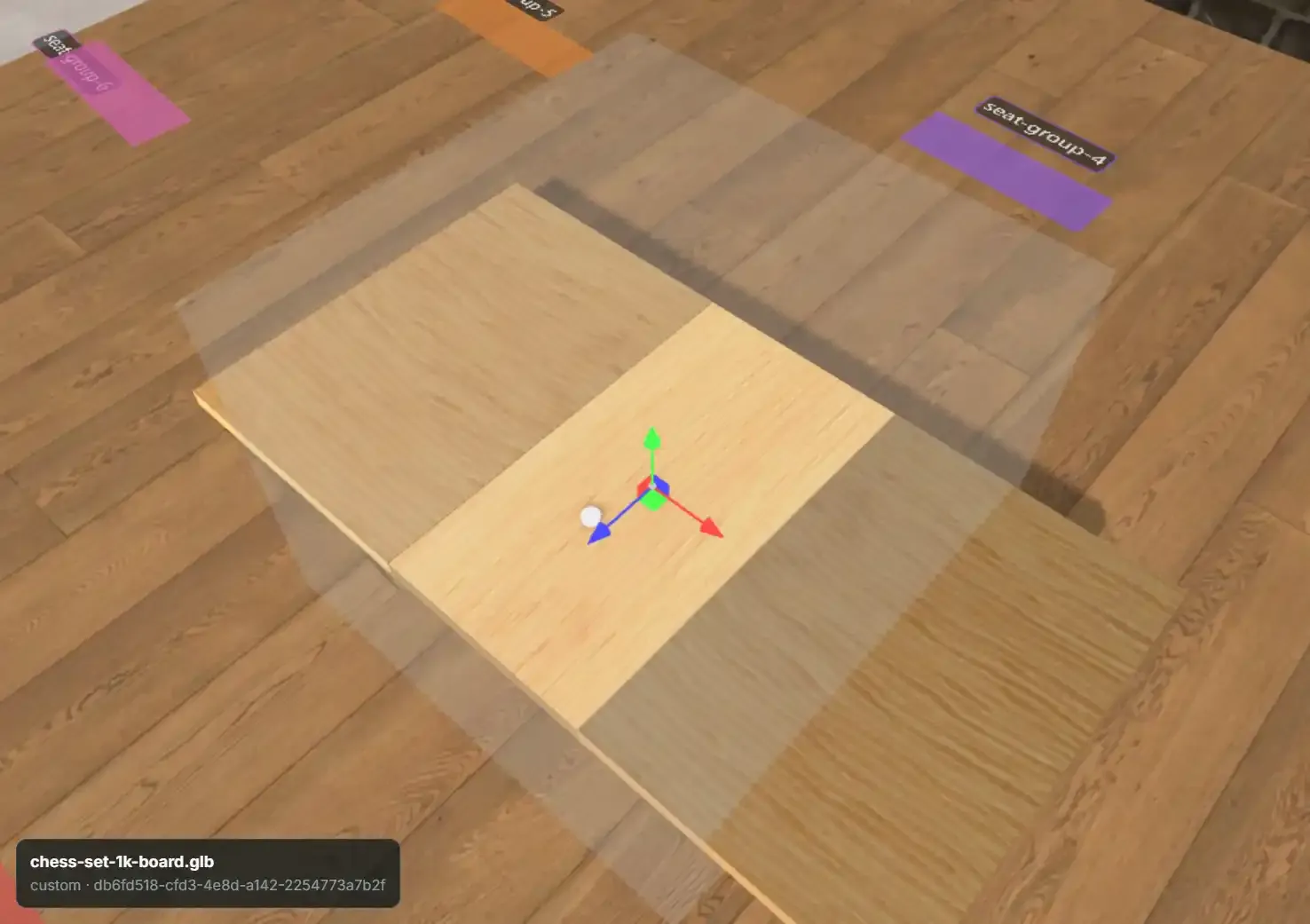 The 3D stage showing the table, a selected board entity with its move gizmo, and the selection-overlay strip naming the entity